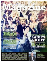En blond kvinna står mitt bland skrattande människor i en folkmassa och pekar på kameramannen. Det här är omslaget till tidningen Enterprise Magazine.